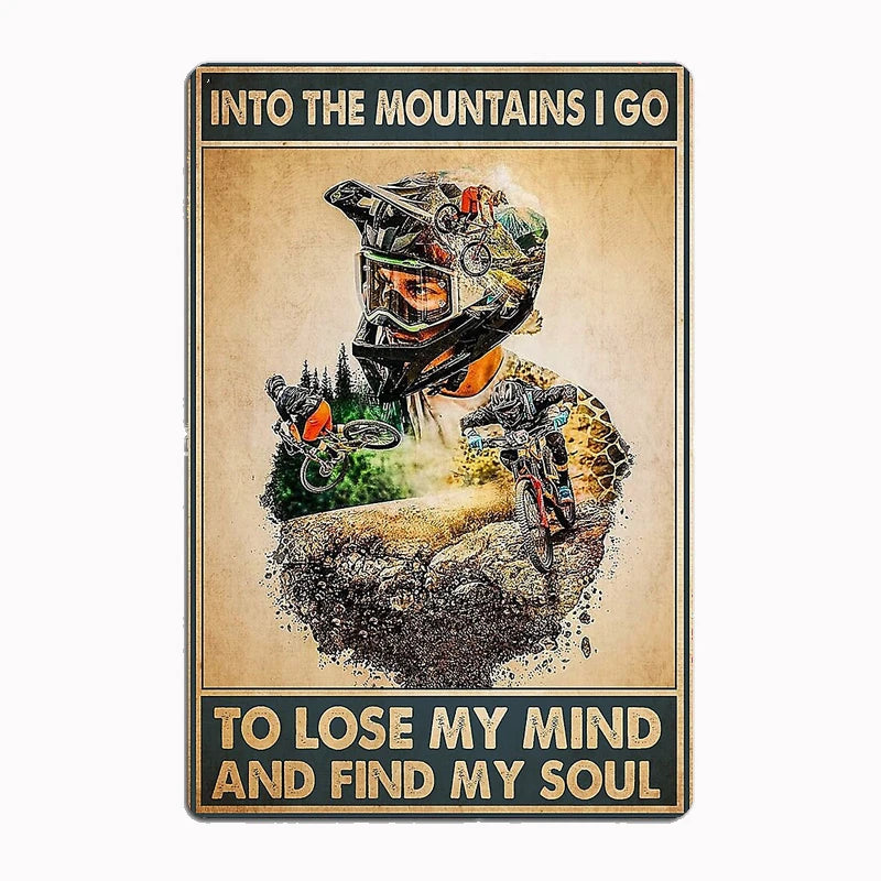 Into the Mountains I Go metal tin sign featuring double-exposure design of mountain biker merged with mountain landscape and inspirational quote about losing mind and finding soul