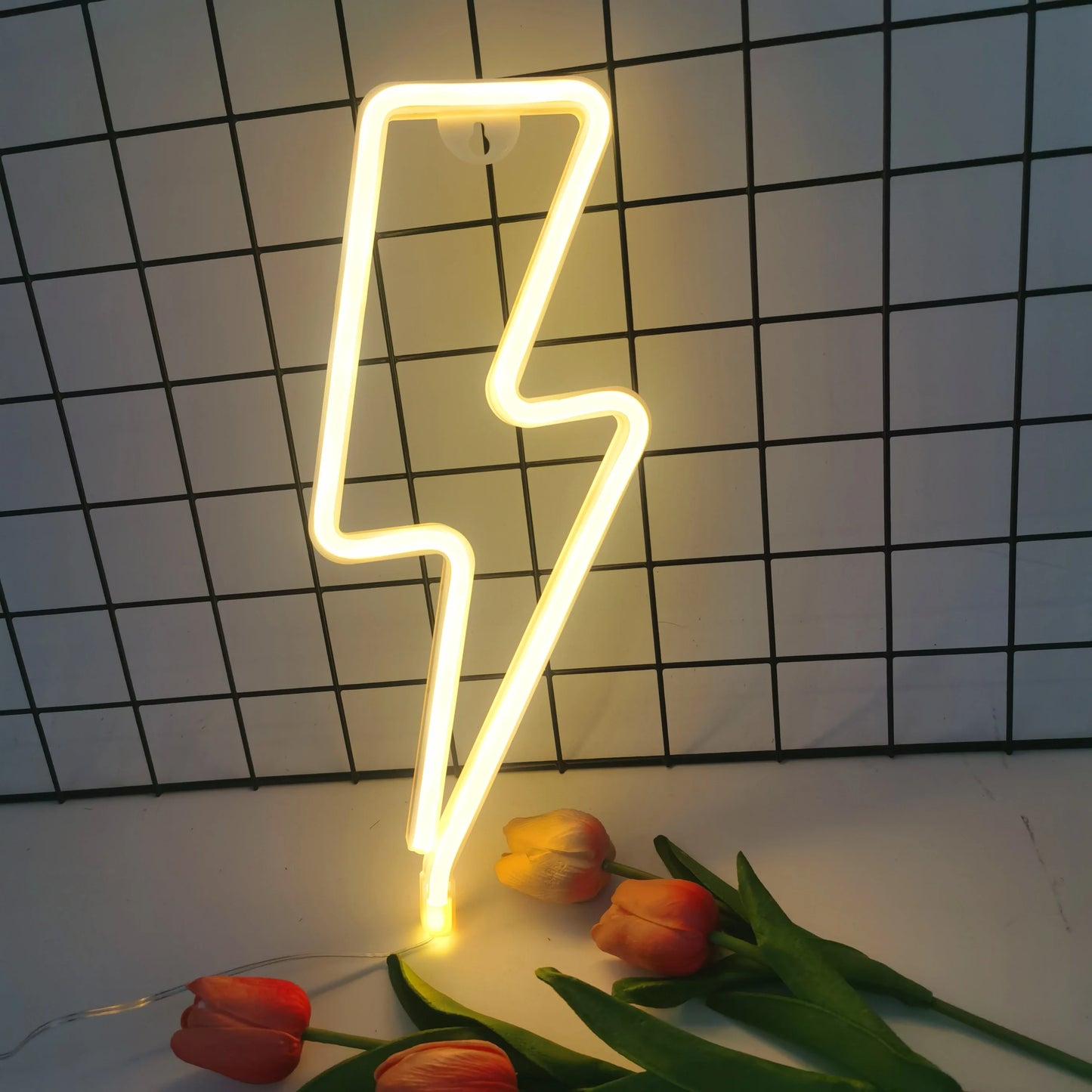Lightning bolt LED neon wall light in yellow on brick wall background