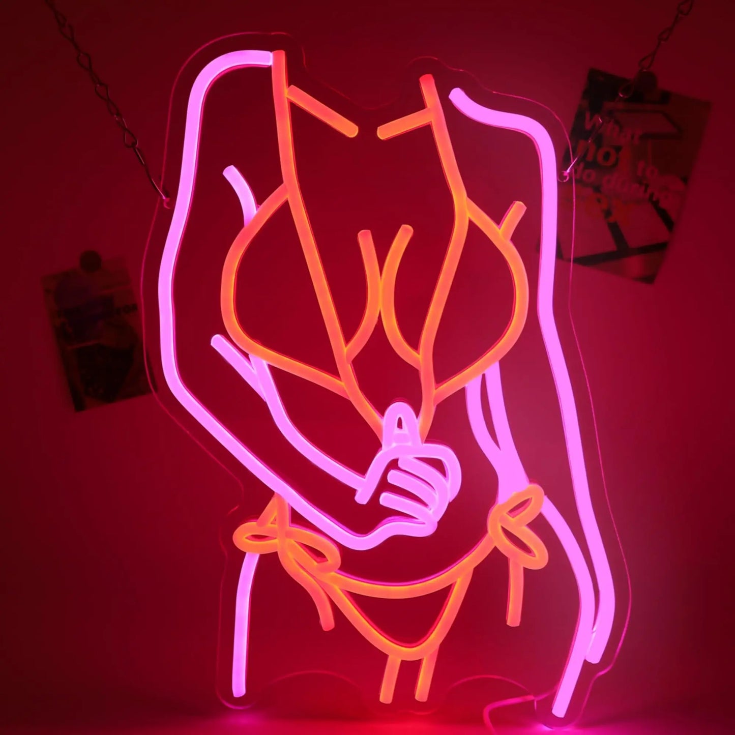 Rose neon sign lifestyle shot showing wall installation with vibrant pink glow in dark ambient setting - sign on chains