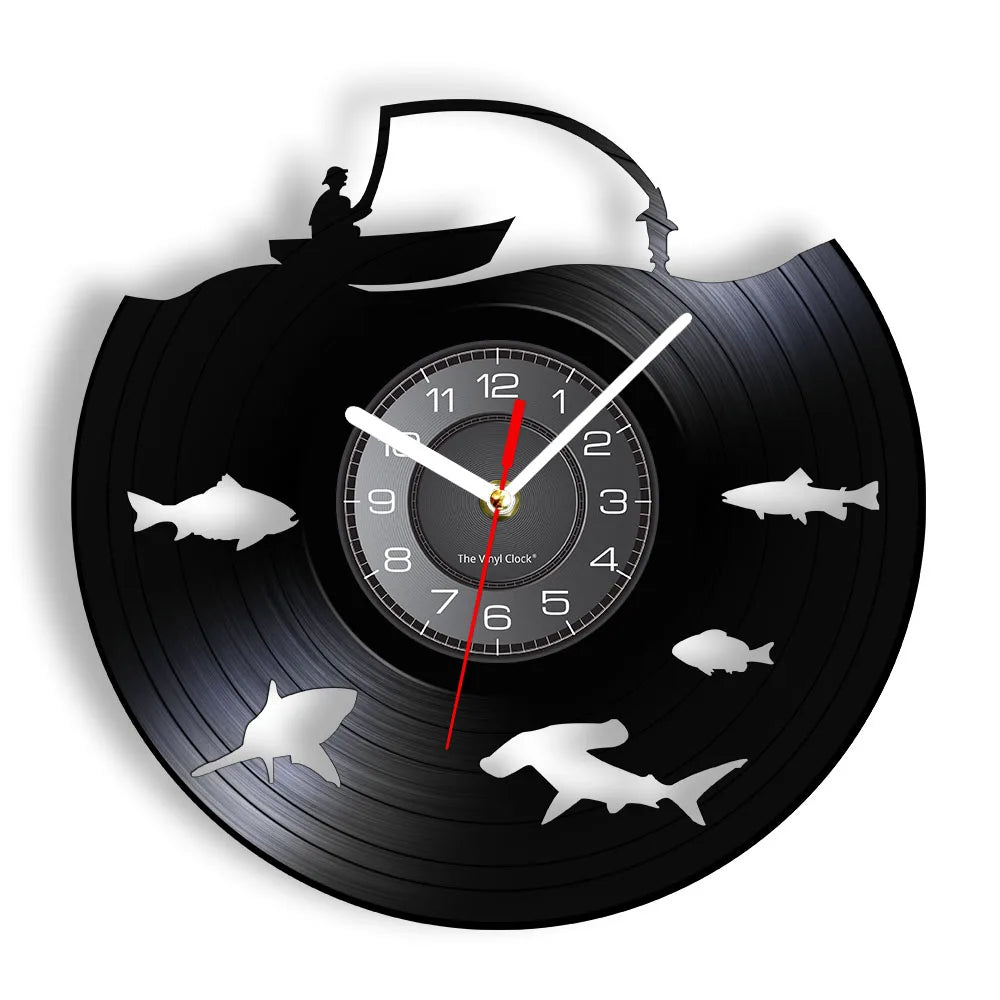 Fishing vinyl record wall clock featuring intricate laser-cut design with swimming fish silhouettes circling around clock face on black vinyl record