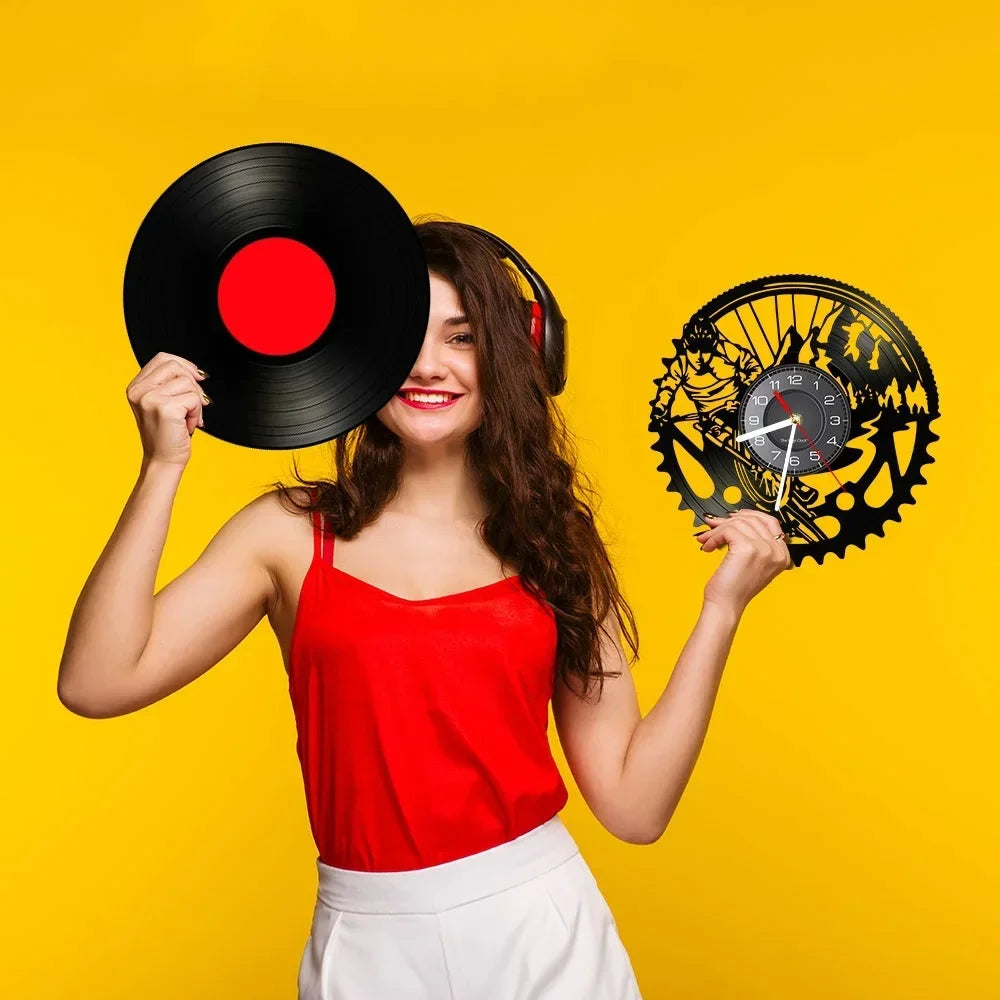 Woman holding a vinyl record and a vinyl clock against a yellow background