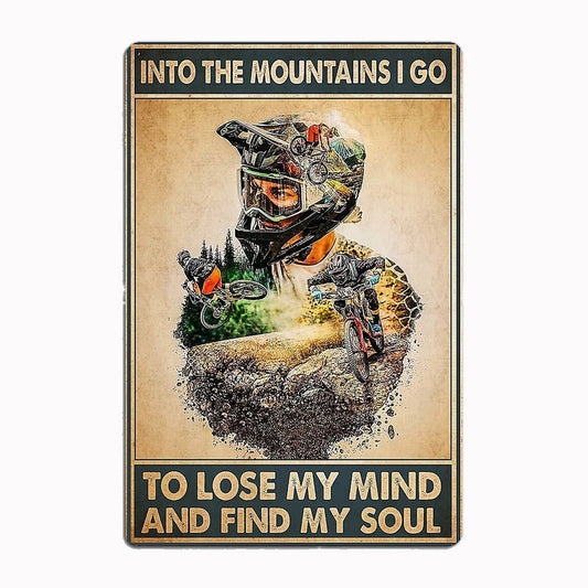 Into the Mountains I Go metal tin sign featuring double-exposure design of mountain biker merged with mountain landscape and inspirational quote about losing mind and finding soul
