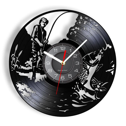 Fishing vinyl record wall clock featuring intricate laser-cut design with fisherman reeling in large fish with dramatically bent rod, fish jumping powerfully out of water creating splashes, cattails and water plants on black vinyl record