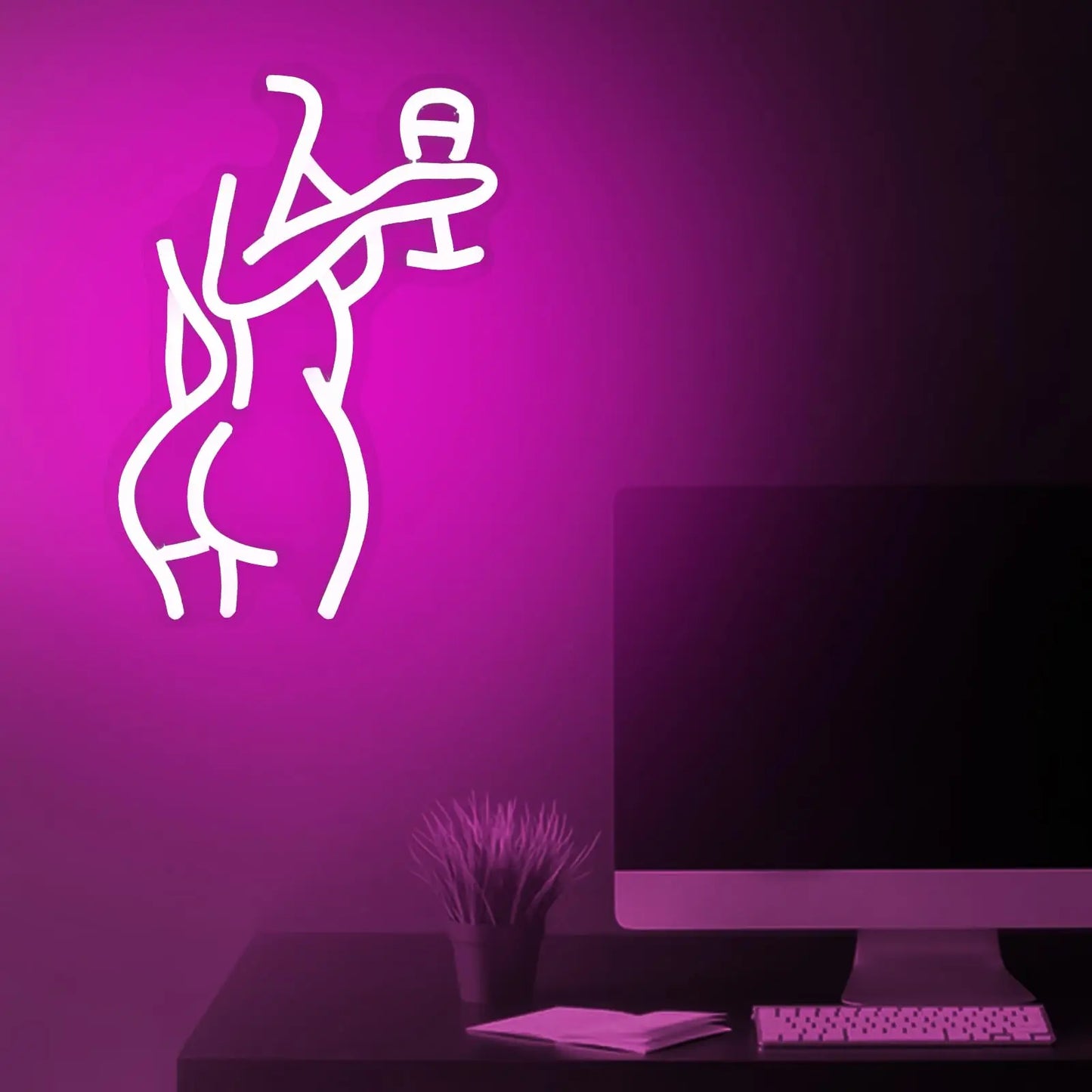 Dancing woman neon sign lifestyle shot showing vibrant pink glow in dark ambient setting