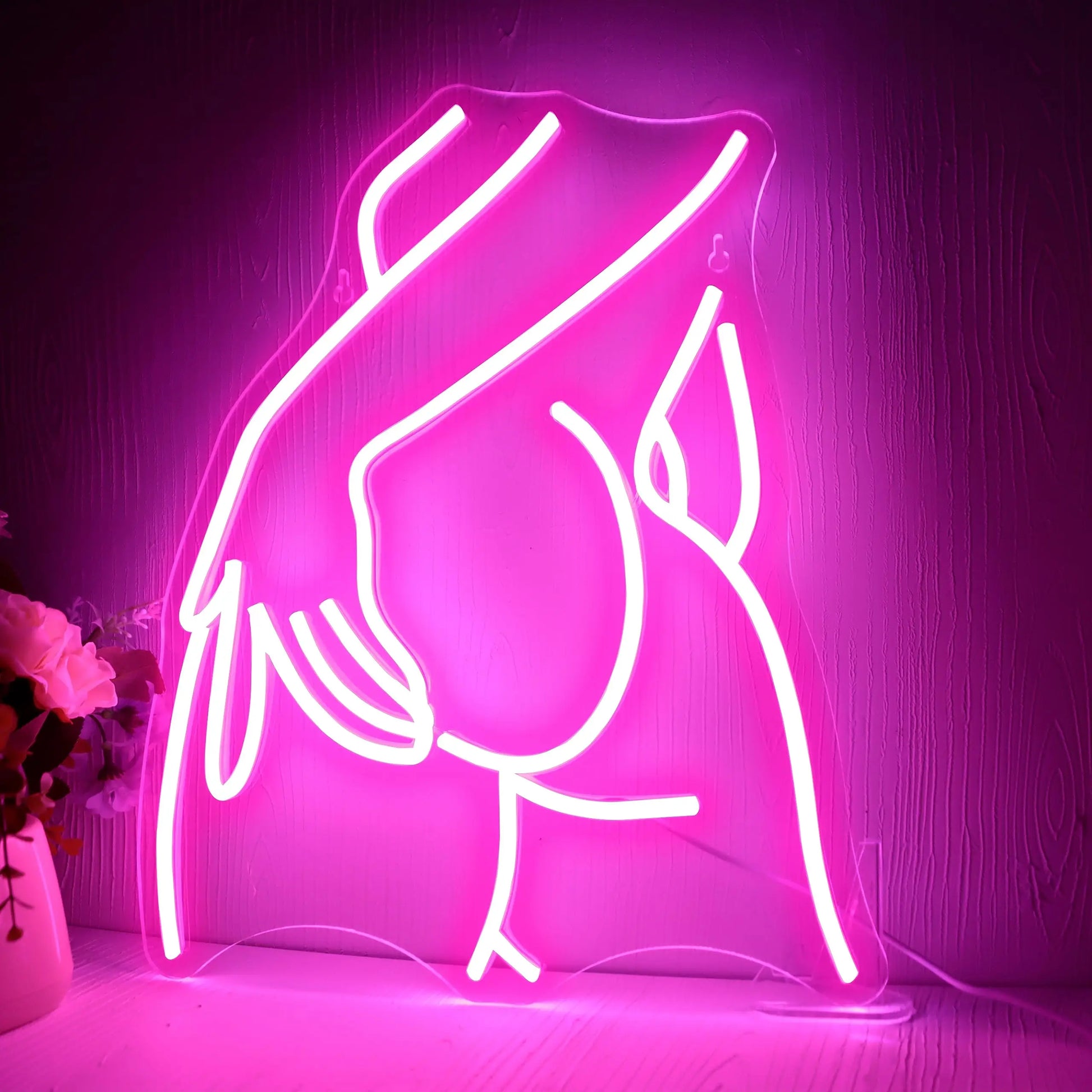 Curvy woman silhouette LED neon sign in vibrant pink featuring bold feminine figure design for bedroom or bar wall decor