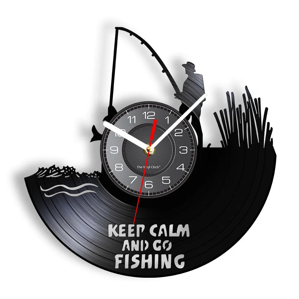 Fishing vinyl record wall clock featuring intricate laser-cut design with Keep Calm and Go Fishing text, fisherman casting with rod and reel, and cattails on black vinyl record