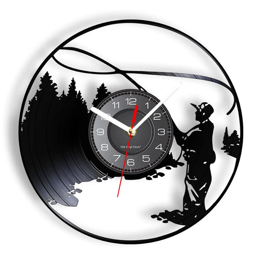 Fly fishing vinyl record wall clock featuring intricate laser-cut design with fly fisherman standing in water casting line with graceful arc overhead, surrounded by evergreen trees and mountain landscape on black vinyl record