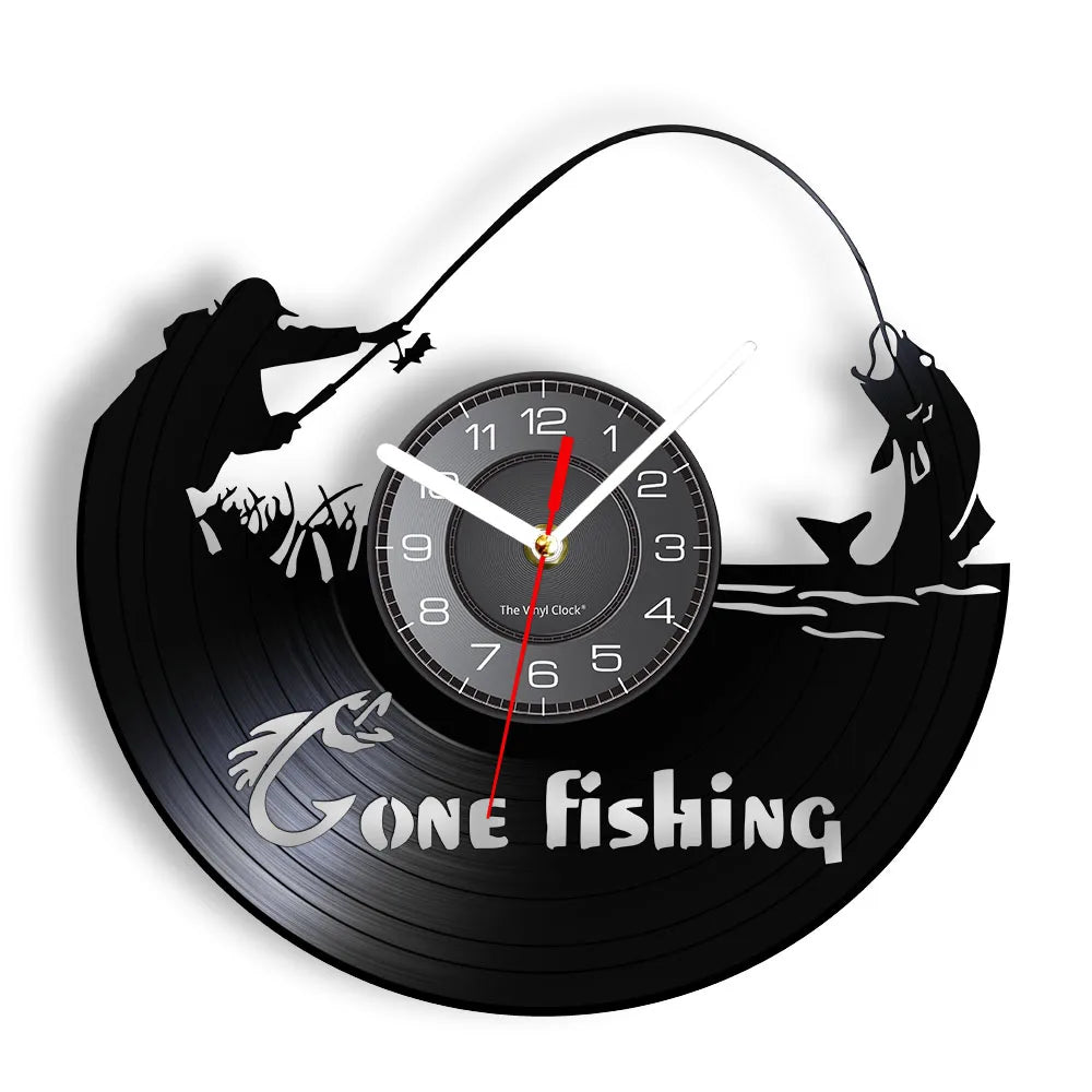 Gone Fishing vinyl record wall clock featuring intricate laser-cut design with two fishermen in boat, one casting line with arcing rod and one reeling in catch, with bold Gone Fishing text on black vinyl record