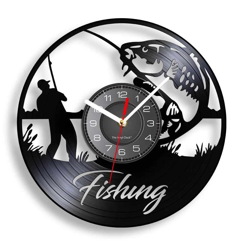 Fishing vinyl record wall clock featuring intricate laser-cut design with fisherman casting line from shore, large fish jumping dramatically out of water, cattails and water plants, and elegant Fishing script text on black vinyl record
