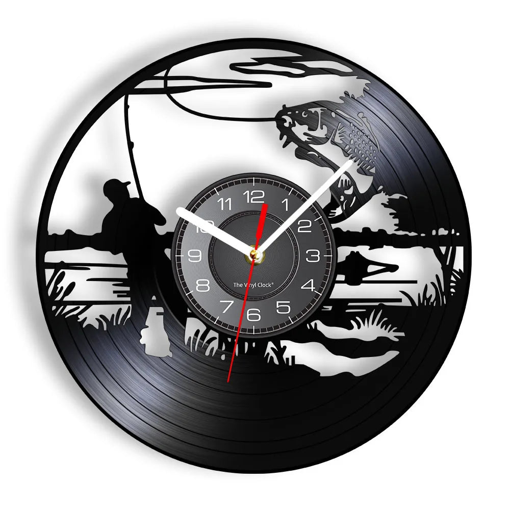 Fishing vinyl record wall clock featuring intricate laser-cut design with fisherman casting line from shore, cattails, water plants, and scenic lake backdrop with trees and mountains on black vinyl record