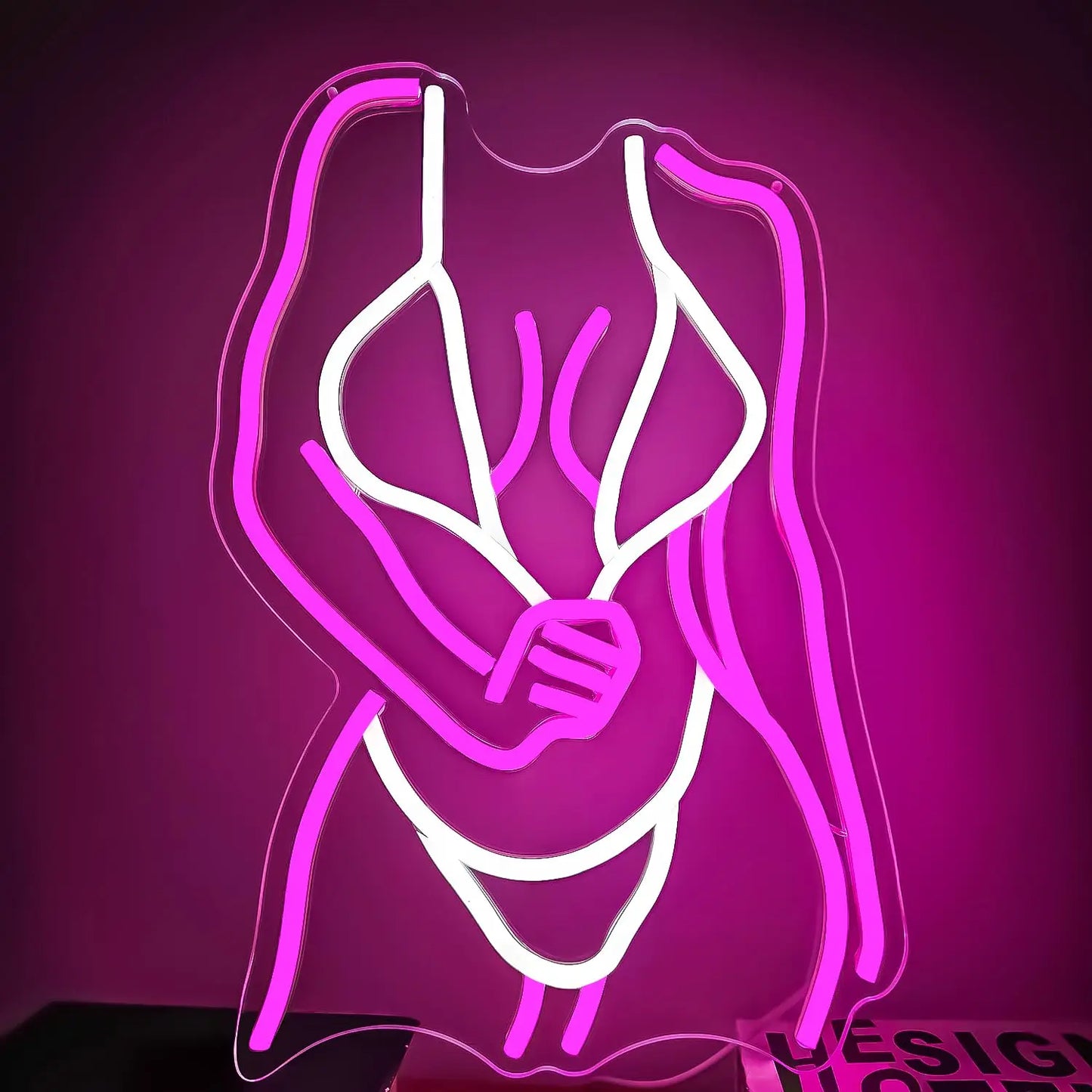 Curvy woman figure neon sign detail view highlighting bold feminine silhouette and neon glow effect
