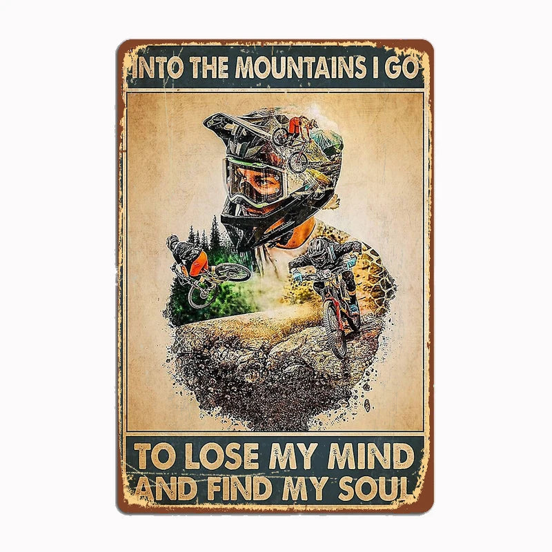 Into the Mountains I Go vintage metal tin sign featuring double-exposure design of mountain biker merged with mountain landscape and inspirational quote with classic distressed edges and sepia tones