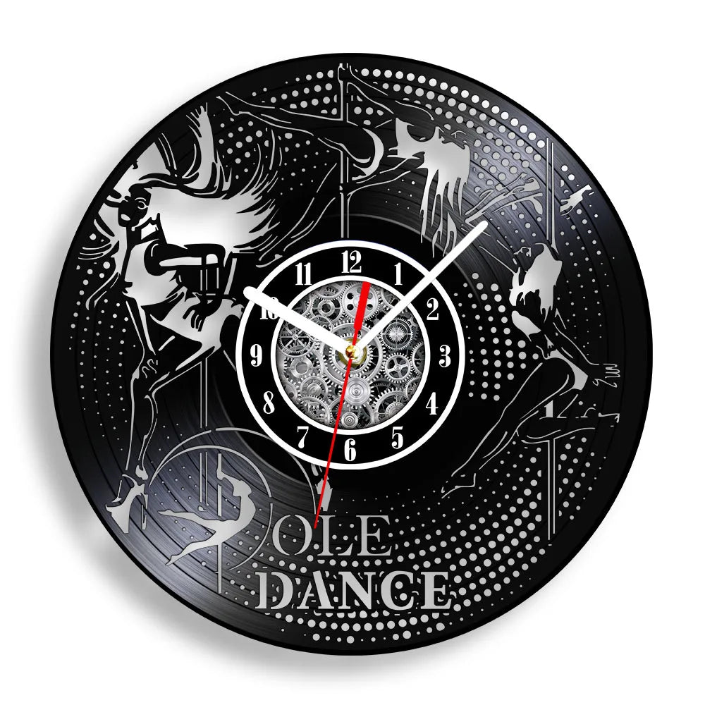 Pole Dance vinyl record wall clock featuring intricate laser-cut dancer silhouette performing on pole with graceful poses, POLE DANCE text, and decorative stars on black vinyl record