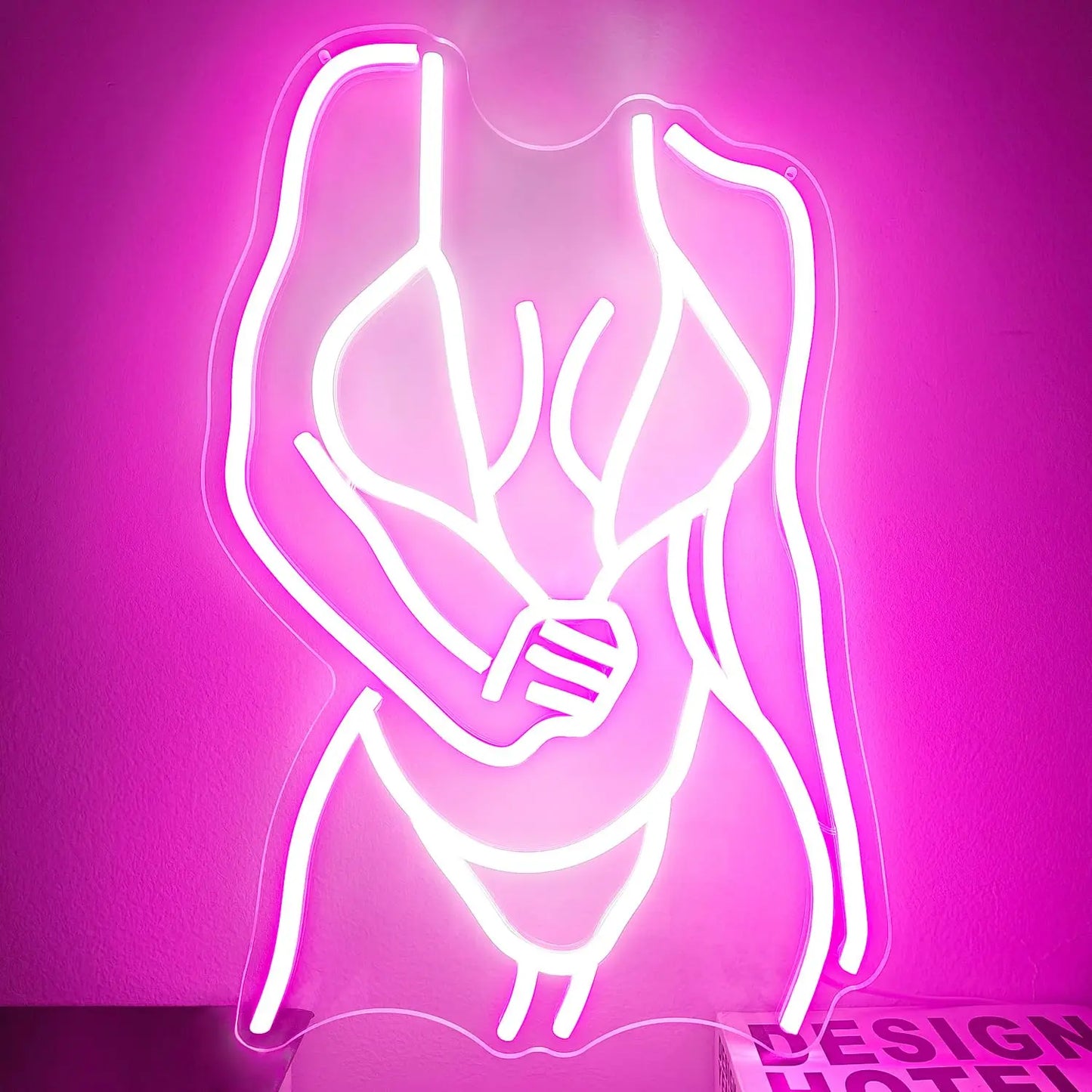 
Curvy woman figure pink neon wall light close-up showing smooth illumination and elegant curves